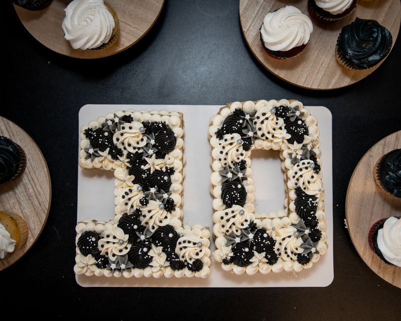 Number 10 cookie cake surrounded by cupcakes