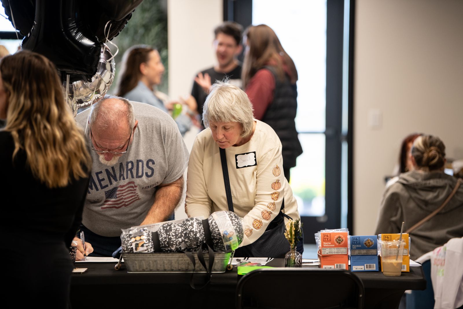 Guests gathered around a demo table at the Motion MN 10th Anniversary celebration